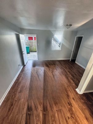 Living room with wood-look floor in a 2-bedroom Metairie home