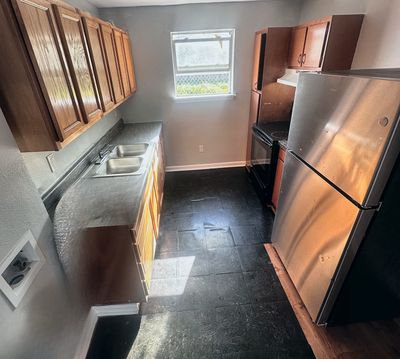 Kitchen with wood cabinets in a 2-bedroom Metairie home