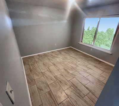 Bedroom with large window in a 2-bedroom Metairie home