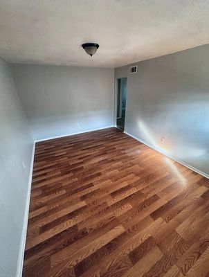 Living room with wood-look floor in a 2-bedroom Metairie home
