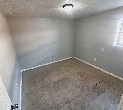 Bedroom with plank floor in a 2-bedroom Metairie home