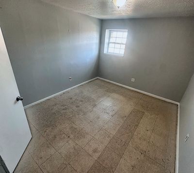 Bedroom with plank floor and ceiling light in a 2-bedroom Metairie home