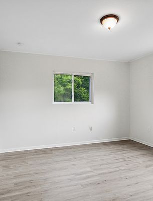Bedroom with window and ceiling light in a 1-bedroom New Orleans East home