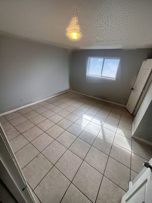 Bedroom with tile floor and window in a 1-bedroom New Orleans East home