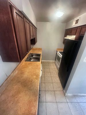 Kitchen with wood cabinets in a 1-bedroom New Orleans East home