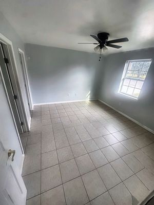 Bedroom with ceiling fan and tile floor in a 1-bedroom New Orleans East home