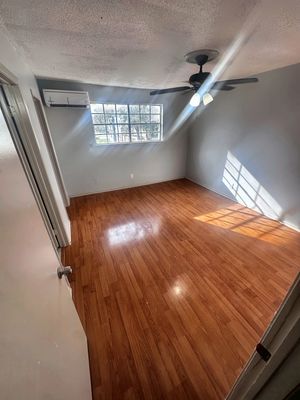 Bedroom with ceiling fan and wood-look floor in a 1-bedroom New Orleans East home