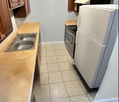 Kitchen with refrigerator and tile floor in a 1-bedroom New Orleans East home