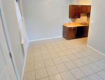 Living and dining area with tile floor in a 1-bedroom New Orleans East home