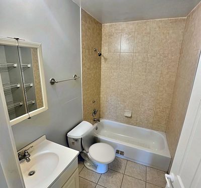 Bathroom with tub and tiled walls in a 1-bedroom New Orleans East home