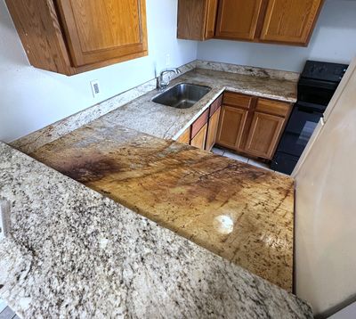 Kitchen with granite counters and wood cabinets in a 2-bedroom New Orleans East home