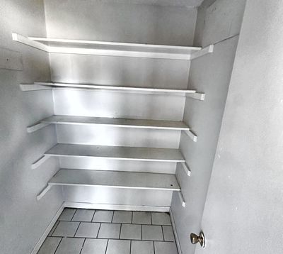 Pantry with wire shelves in a 2-bedroom New Orleans East home