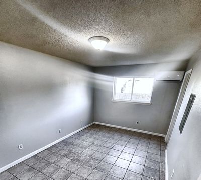 Bedroom with tile floor and window in a 2-bedroom New Orleans East home