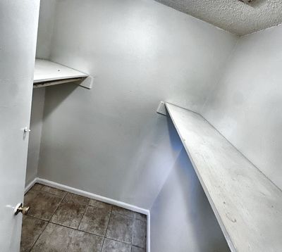 Walk-in closet with shelves in a 2-bedroom New Orleans East home